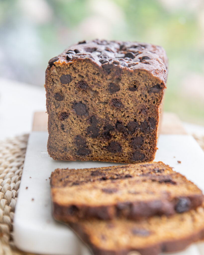 Sliced gluten-free pumpkin peanut butter banana bread with melted chocolate chips